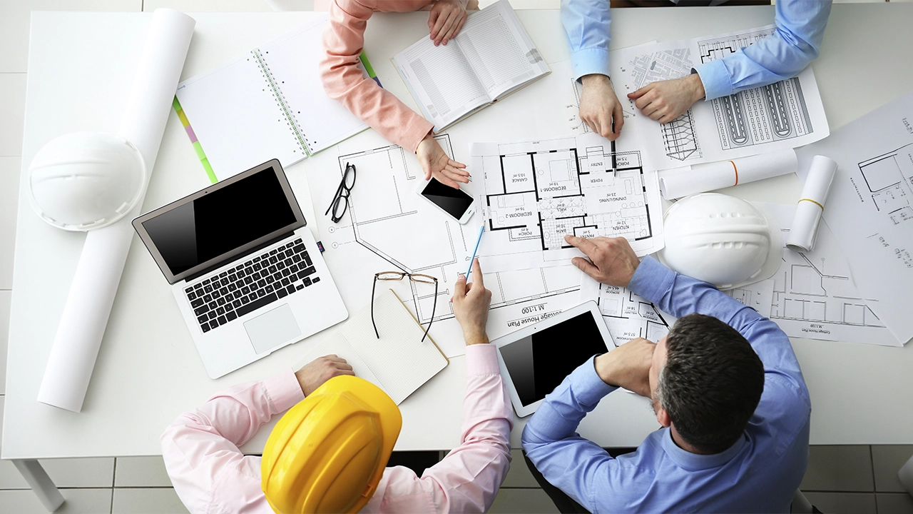 Construction team reviewing architectural plans on site