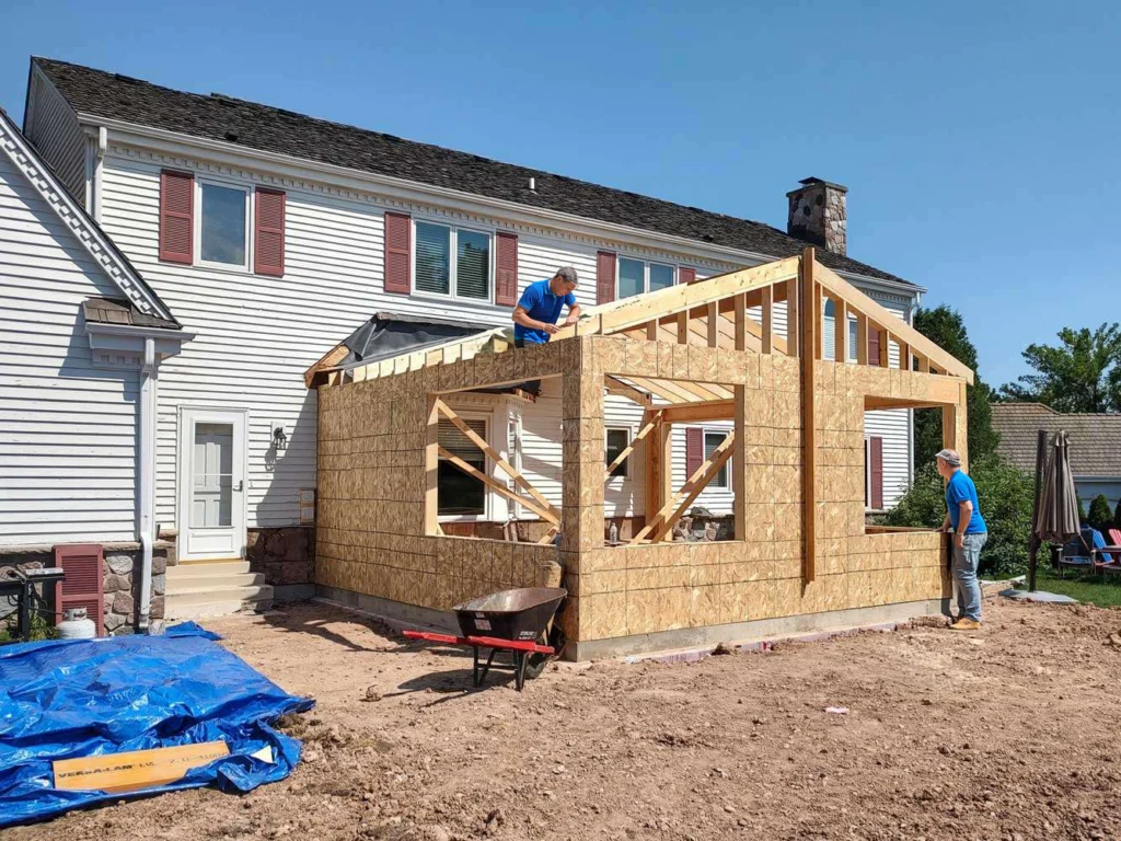 Home addition construction in Maryland with new framed extension attached to a house