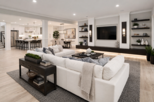 Modern finished basement remodeling with an open-concept living room, custom media wall, recessed lighting, built-in shelves, and upscale entertainment space.