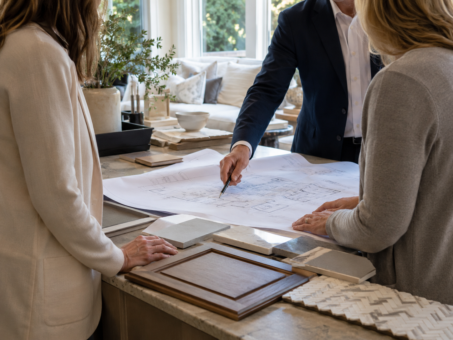 Design-build team reviewing renovation plans with Maryland homeowner